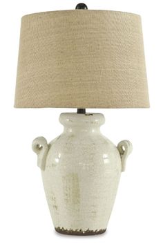 a white ceramic lamp with a beige shade