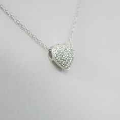 Single cut diamonds are pave set into this 14k white gold heart pendant. A Singapore white gold chain is the perfect addition to complete this necklace. Metal: 14K White Gold Necklace Length: 16 Inches Pendant Length x Width: 3/8 x 3/8 Inches Diamonds: .17 CTW, SI1 E-F For a greater selection of jewelry please visit our website at www.BlackMarketLLC.com If you have any questions about this product or if we can help you with any of our other products please contact us through Etsy or our website Gold Heart Pendant, White Gold Chain, White Gold Necklace, Heart Pendant Gold, White Gold Chains, Heart Pendant Diamond, White Gold Necklaces, Alternative Engagement Rings, Gold Heart