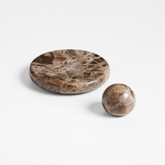 two brown marbles sitting on top of each other