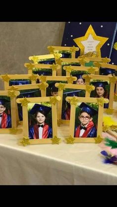 a table topped with pictures of people in graduation caps and gowns