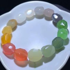 "This multi color jade and agate bracelet is another fun piece with great craftsmanship.  Each bead has hand created surface texture. The beads are made of Nanhong agate, African agate, white jade, sugar jade, white jade,  yanzi purple jade, oufen lotus pink jade, apple green jade, pastel green jade, Burmese yellow jade, etc. A collection of most popular Hetian jade colors. Fits up to wrist 6\" with elastic string. Cannot be adjusted. Bead diameter about 9x 12mm.  随形多宝手串，糖果色，和田玉碧玉，晴水，黄口，南红，缅黄，糖玉，白玉，藕粉，烟紫，渐变色排列，色很亮，料子精选，细腻油润，手工雕刻，很讨喜，尺寸12x9mm" Multicolor Jade Round Beads Crystal Bracelet, Multicolor Jade Beaded Crystal Bracelet, Multicolor Jade Bead Crystal Bracelet, Multicolor Jade Crystal Bracelet With Round Beads, Faceted Agate Bead Bracelets, Multicolor Agate Gemstone Crystal Bracelet, Multicolor Jade Beaded Bracelets, Multicolor Agate Crystal Bracelet With Round Beads, Multicolor Agate Round Beaded Bracelets