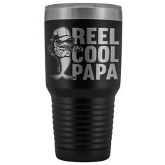 a black and silver tumbler with the words reel cool daddy on it, in white lettering