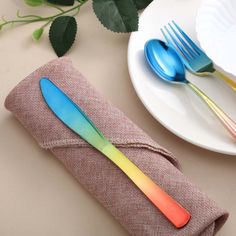 two forks and spoons are sitting on a napkin next to a plate with flowers