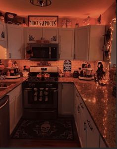 a kitchen filled with lots of counter space next to a stove top oven and microwave