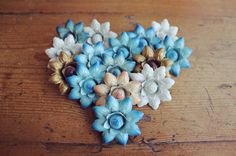 several blue and white flowers sitting on top of a wooden table