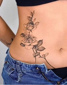 a woman with a flower tattoo on her stomach