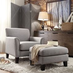 a chair and ottoman in a room with brick wall, rugs and flooring