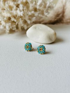 Make your everyday outfit more shiny wearing these turquoise/gold beaded post earrings. These statement stud earrings are made from Miyuki Delica seed beads and supplied with stainless steel accessories. So lightweight and comfortable to wear, these dainty beaded studs would be the perfect addition to your holiday look. If you're looking for delicate seed bead earrings for winter, this pair is a great finding for you. Also, these minimalist earrings are making a great Christmas gift for bohemian Turquoise Earrings With Gold Beads For Gift, Turquoise Earrings With Tiny Beads For Gift, Beaded Studs, Steel Accessories, Stainless Steel Accessories, Christmas Bead, Dainty Studs, Earrings Christmas, Round Stud Earrings