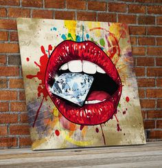 a painting on a brick wall with a diamond in it's mouth and red lips