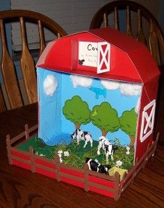 a box with cows painted on it sitting on a table