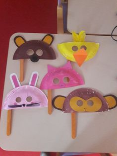 some paper plates with animal masks on them