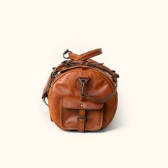 Full Grain leather travel duffle bag Cognac Travel Backpack With Leather Lining, Cognac Backpack With Leather Lining For Travel, Travel Backpack With Leather Lining In Cognac, Rugged Bags With Leather Handles And Oiled Leather, Travel Leather Backpack In Cognac With Leather Handles, Cognac Leather Trim Shoulder Bag For Travel, Brown Travel Accessories With Leather Handles, Cognac Leather Backpack With Leather Handles For Travel, Travel Shoulder Bag With Leather Trim In Cognac