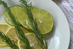 sliced lemons and rosemary on a white plate