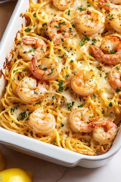 a casserole dish filled with shrimp and pasta