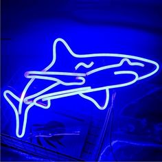 a neon sign with a shark on it