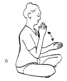 a woman sitting on the ground with her hands clasped to her chest, and praying