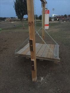 a wooden platform with a life preserver attached to it in the middle of a field