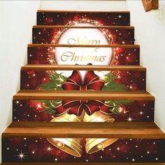 stairs decorated with christmas decorations and bells on the bottom, along with merry christmas lettering