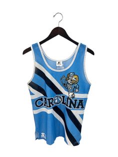 "early 90s UNC tank. by starter. carolina blue, navy, & white. sublimated graphics. side slits. 22.5\" long.  19\" across. in good, used condition. made in USA. legit. legitvintage.etsy.com legitvintage on instagram" Blue Sports Fan Tops For Fan Gear, Cotton Team Spirit Tank Top, Team Spirit Cotton Sleeveless Tank Top, Collegiate Sleeveless Tops For Sports Season, Sleeveless Tops For Sports Events With Team Spirit, Collegiate Sleeveless Tank Top For Sports Events, Sleeveless Tops For College Summer, Sleeveless Summer Tops For College, Blue Sports Fan Tops For College