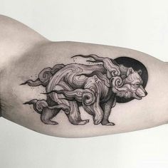 a man's arm with a bear tattoo on it