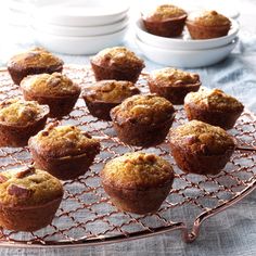 muffins on a wire cooling rack with white bowls in the backgroud