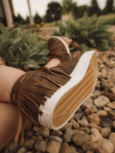 Sneakers that turn heads. Super comfortable, vintage leather with buck stich seams, and a fun fringe heel. These lace up sneakers are a must have if you love western/boho looks. All Agave Sky sneakers are available in whole sizes and run a little large. Half sizes should order the next size down. ex: 7.5 would order a 7. Get these sandals branded to add a personal touch and stand out! Genuine leather Size DOWN if you are in between sizes Made in Mexico Rubber sneaker sole Boho Looks, Rubber Sneakers, Fringe Heels, Denim Wear, Wild Hair, Lace Up Sneakers, Western Boho, Custom Graphics, Sandals Brands