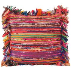 a multicolored pillow with fringes on the front and back, sitting on a white background