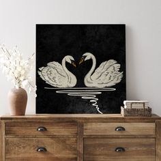 two white swans in the water on a black and white background framed canvas art print