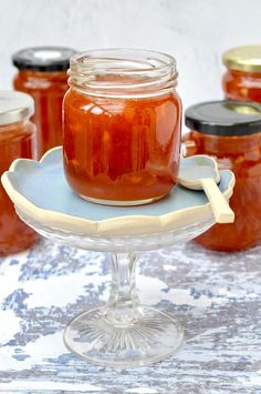 several jars of jam sit on a tray