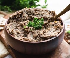 a wooden bowl filled with meat and broccoli