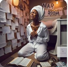 a woman sitting on the floor in front of a wall covered with notes