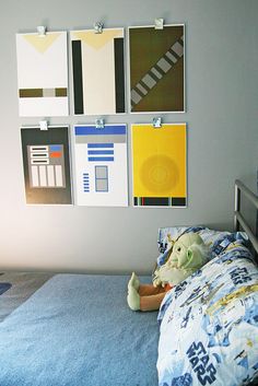 a child's bedroom with star wars posters on the wall above the bed and toys