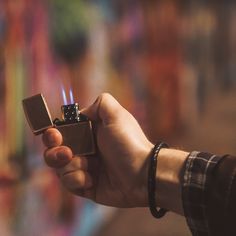 a person holding a lighter in their hand