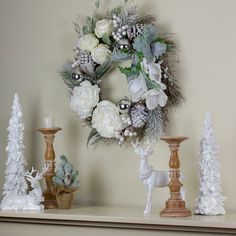 a christmas wreath on top of a mantle