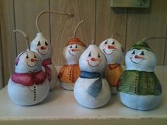 five snowmen are lined up on the counter