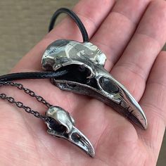 Raven Skull Necklaces - Pewter Two Sizes to Choose From! Pendant: PewterApprox. Sizes: Small: 0.6" wide x 1.1" tall x 0.5" depth, 6 grams.X-Large: 1.1" wide x 2.4" tall x 0.6" depth, 38 grams.Necklace: Small gets a 21" black chain, Large gets a 24" black 3mm cord. Worldwide shipping available!US Customers: Typically ships in 1 business day, delivers in 2-5 days.Outside of US: See shipping options during checkout.Share on social media: Skull Necklaces, Raven Skull Necklace, Raven Skull, Skull Necklace, Black Chain, Necklaces, Ships, Social Media, Chain