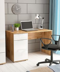 a computer desk with a laptop on it and a clock mounted to the wall behind it