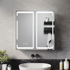 a bathroom with a sink, mirror and soap dispenser