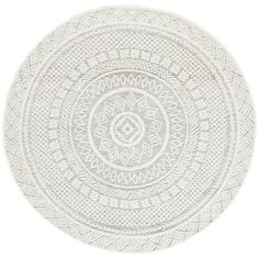 a white round rug with an intricate design