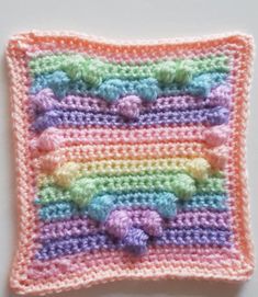 a crocheted square with hearts on it