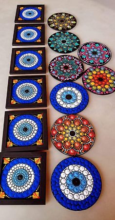 several plates are arranged in rows on the floor next to each other, with different designs and colors