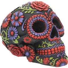 a black and red skull with flowers on it