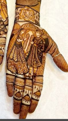 two hands with henna designs on them