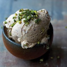 a bowl filled with ice cream and pistachio sprinkles on top