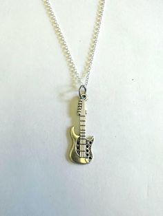 Guitar Charm Necklace. Silver tone finish. Lightweight and easy to wear. 24 inch chain. Guitar Necklace, Pick Necklace, Guitar Pick Necklace, Charm Necklace Silver, List Ideas, How To Get Money, Charleston Sc, Guitar Pick, Necklace Silver