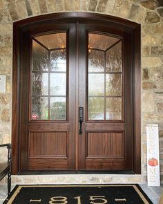 a pair of double doors with numbers on the front and side walk in front of it