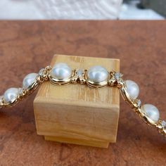 Estate/ vintage 14KT yellow gold polished, Mabe pearl links with diamond detailing bracelet. Elegant and high-end piece! Length: 7" Width: 15mm Weight: 42.6 grams Finished back Push in Clasp Double Safety Clasp .59 carat pave diamonds (27) round diamonds SI clarity; G/H color color diamonds Excellent estate condition Classic Diamond Pearl Bracelet For Formal Occasions, Classic Gold Diamond Pearl Bracelet, Classic Gold Pearl Bracelet With Diamonds, Formal Round Diamond Pearl Bracelet, Gold Diamond Pearl Bracelet For Anniversary, Elegant Yellow Gold Diamond Pearl Bracelet, Gold Pearl Bracelet For Formal Occasions, Gold Pearl Bracelet For Formal Events, Diamond Pearl Bracelet In Yellow Gold For Anniversary