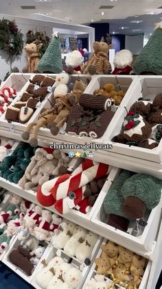 shelves filled with lots of different types of stuffed animals and christmas decorations on display in a store