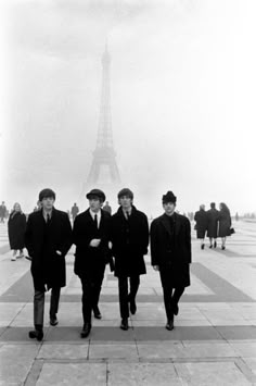 the beatles are walking in front of the eiffel tower, paris, france