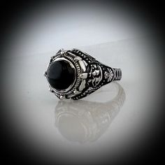 Our Version of the ring Johnny Depp wore in the movie Dark Shadows but we have made it in all sterling silver with a Black Onyx Stone set into the ring. Face of Ring is 20 mm wide by 18 mm high Set with a genuine Black Onyx Stone. Made in our studio by our own skilled silversmith artisans it has been oxidized to give it an antique look. We make to size so you need to provide us with your ring size in US or UK. Delivery is by DHL Express included in price. It takes around 10 to 14 days to make th Silver Victorian Signet Ring With Polished Finish, Victorian Silver Signet Ring With Polished Finish, Gothic Style Silver Ring With Gemstone, Gothic Silver Ring With Gemstone, Luxury Sterling Silver Skull Ring, Black Skull Ring With Open Design As Gift, Black Open Skull Ring As A Gift, Black Stainless Steel Ring With Polished Finish, Gothic Oval Gemstone Rings